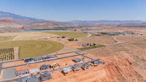 Aerial view of property and surrounding area with a water and mountain view