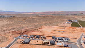 Aerial overview of property's location with a mountainous background, rural landscape, and a desert landscape