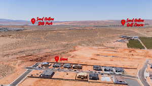 Aerial view of property's location with a mountainous background, rural landscape, and a desert landscape