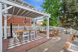 View of patio with outdoor dining space and a pergola