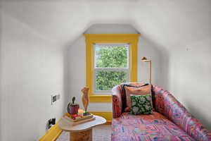 Sitting room featuring lofted ceiling
