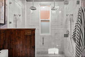 Bathroom featuring a stall shower and toilet