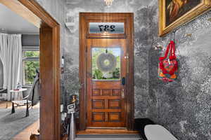 Property entrance featuring stucco siding