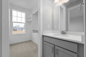 Bathroom with vanity and baseboards