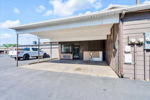 View of exterior entry featuring a carport