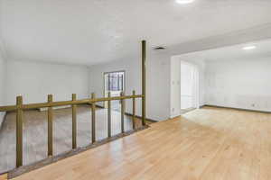 Empty room featuring wood finished floors and baseboards
