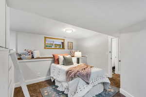 Bedroom featuring carpet floors and baseboards