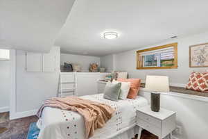 Bedroom featuring carpet floors and baseboards