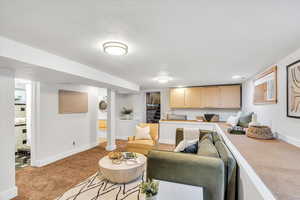 Living area with light colored carpet and baseboards