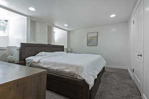 Carpeted bedroom with baseboards and recessed lighting