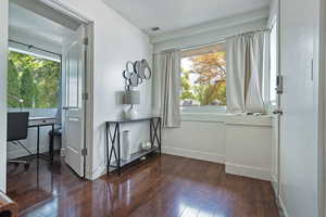Doorway to outside with hardwood / wood-style floors and an office area