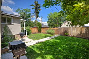 Fenced backyard featuring a patio