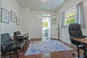 Office featuring dark wood finished floors and baseboards