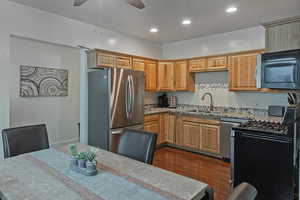 Kitchen with stainless steel appliances, recessed lighting, and a ceiling fan