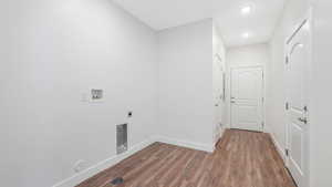 Laundry room with storage and access to the garage and public breezeway