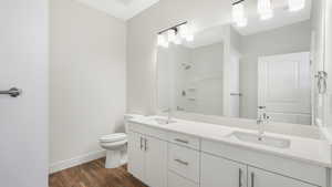 Primary bathroom with double vanity and walk in shower