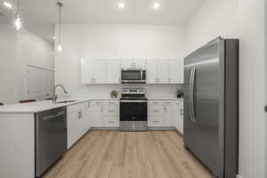 Kitchen with stainless steel appliances, quartz counters, tile backsplash,