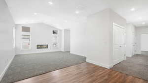 Living room with vaulted ceilings and a cozy fire place