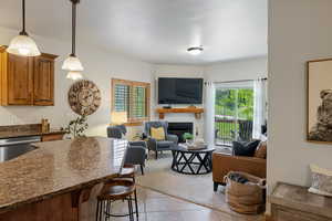 Living area featuring light tile patterned floors and a fireplace
