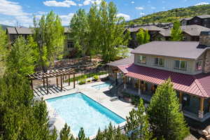Community pool with a pergola, a patio area, and a residential view