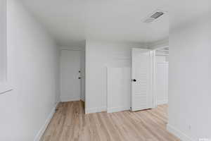 Spare room featuring light wood finished floors and baseboards
