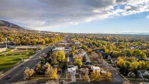 Aerial view of property's location with nearby suburban area and mountains