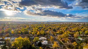 Aerial overview of property's location with mountains and nearby suburban area
