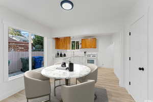 Dining area with baseboards and light wood finished floors