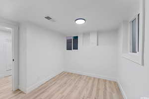 Spare room with light wood finished floors and baseboards