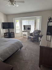 Carpeted bedroom with ceiling fan