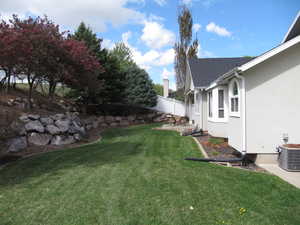 View of yard with central air condition unit and a patio