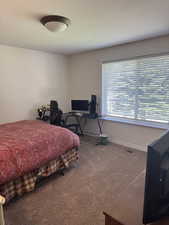 Carpeted bedroom with an office area