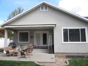Rear view of property featuring stucco siding and a patio