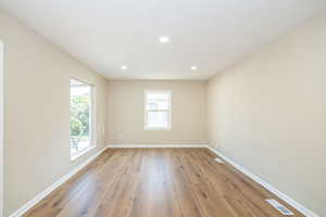 Unfurnished room featuring plenty of natural light, light wood finished floors, baseboards, and recessed lighting