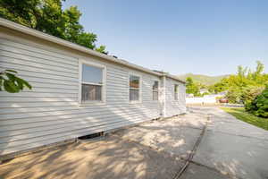 View of home's exterior with a patio area, a mountain view, and central AC