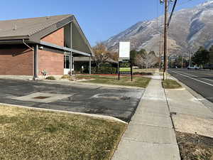 View of home's exterior featuring a mountain view, brick siding, and a tiled roof
