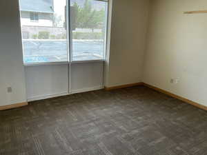 Carpeted spare room with baseboards