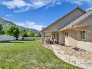 View of yard with a mountain view, and a large, covered patio.
