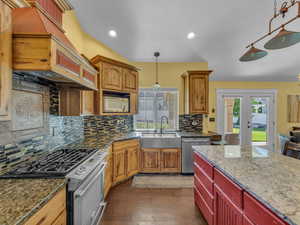 Kitchen featuring appliances with stainless steel finishes, a sink, healthy amount of natural light, french doors, and recessed lighting