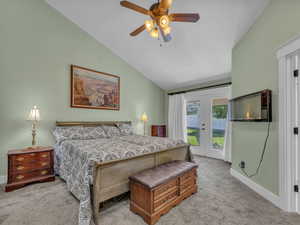 Bedroom featuring access to exterior, light carpet, french doors, vaulted ceiling, and baseboards