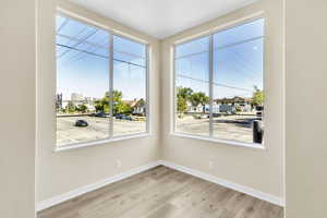 Spare room with light wood-style floors and baseboards