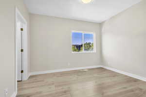 Empty room featuring light wood-style floors and baseboards