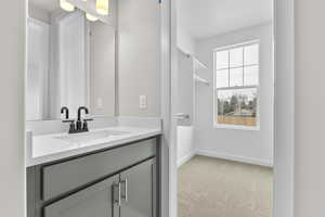 Bathroom with vanity and baseboards