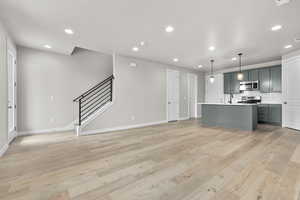 Kitchen featuring stainless steel appliances, a sink, recessed lighting, baseboards, and tasteful backsplash