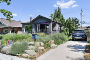 View of front of property featuring brick siding and a chimney
