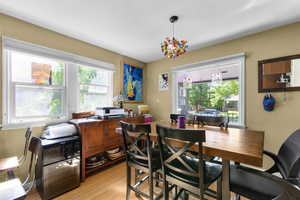 Dining area with light wood finished floors and a desk