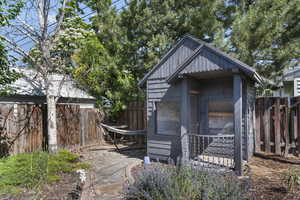 View of outdoor structure with a fenced backyard