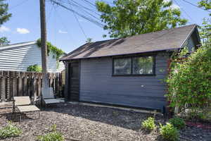 Back of property with an outbuilding
