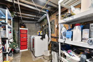 Unfinished basement featuring washing machine and dryer