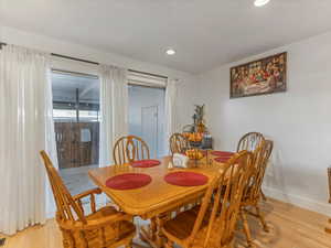 Dining space featuring light wood-style flooring, recessed lighting, and baseboards